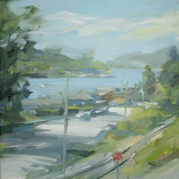 Painting by Canadian artist, Leanne M Christie of Burrard Inlet looking west. The viewer is standing on a street on a hill overlookiing the lower street. The sky and water are a soft blue with the trees described with yellowish greens. The red of the stop sign in front of the railway track adds a nice touch of vibrancy.