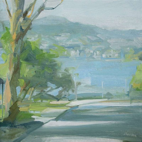 Vancouver based urban oil painter, Leanne M Christie painting of a little side street in Kitsilano with the sea in the background and the North Shore Mountains. Leanne Christie places the viewer on the street so that the view to the North Shore Mountains is unobstructed. The dominant colours are blue, green and grey. Genre: Urban landscape.